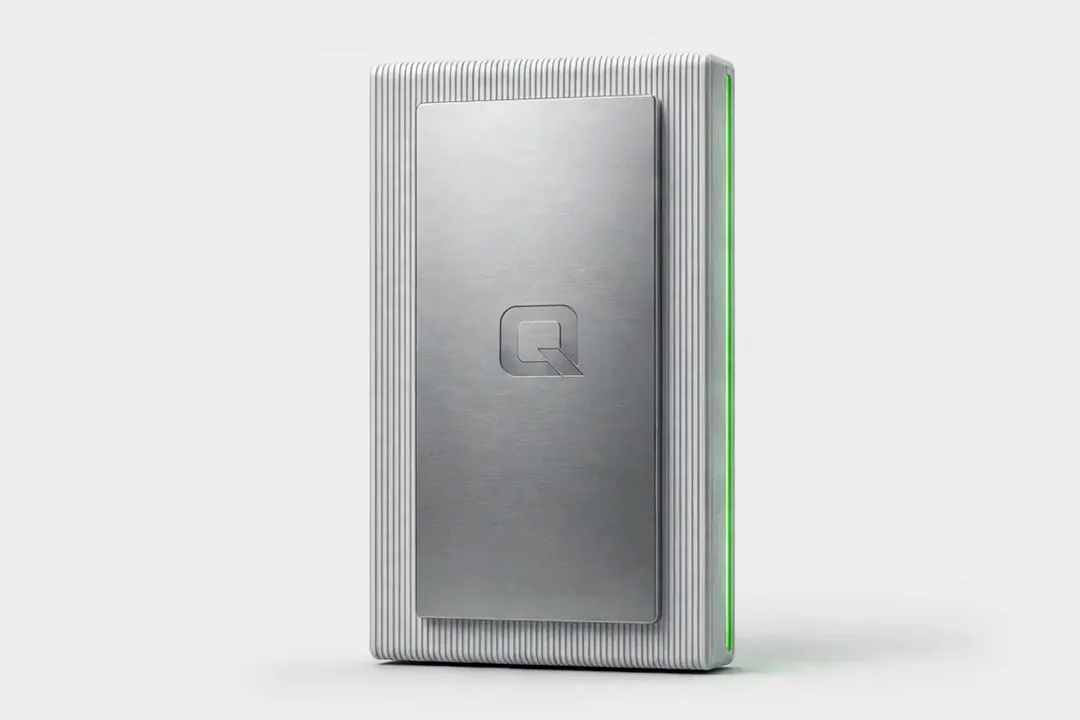 A ribbed silver QED wall unit with a brushed metal plate, an embossed Q and a thin green light line